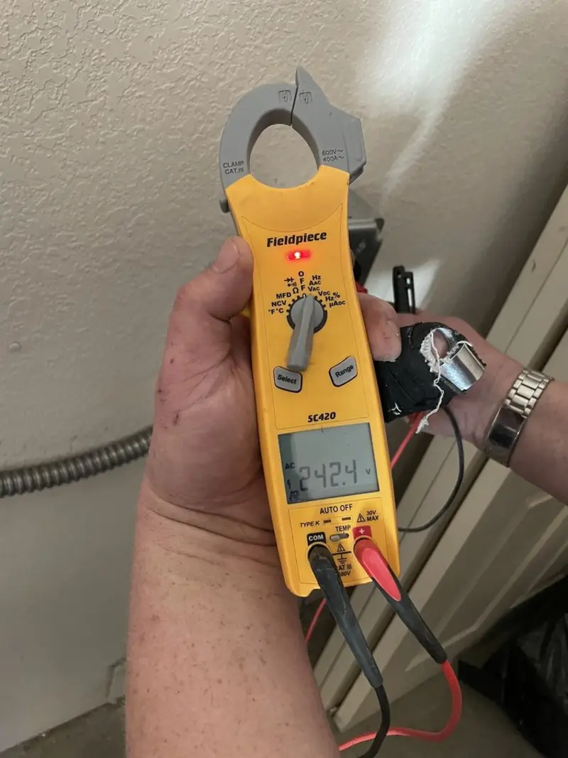 Voltage testing with clamp meter during Ceiling Fan Installation in North East